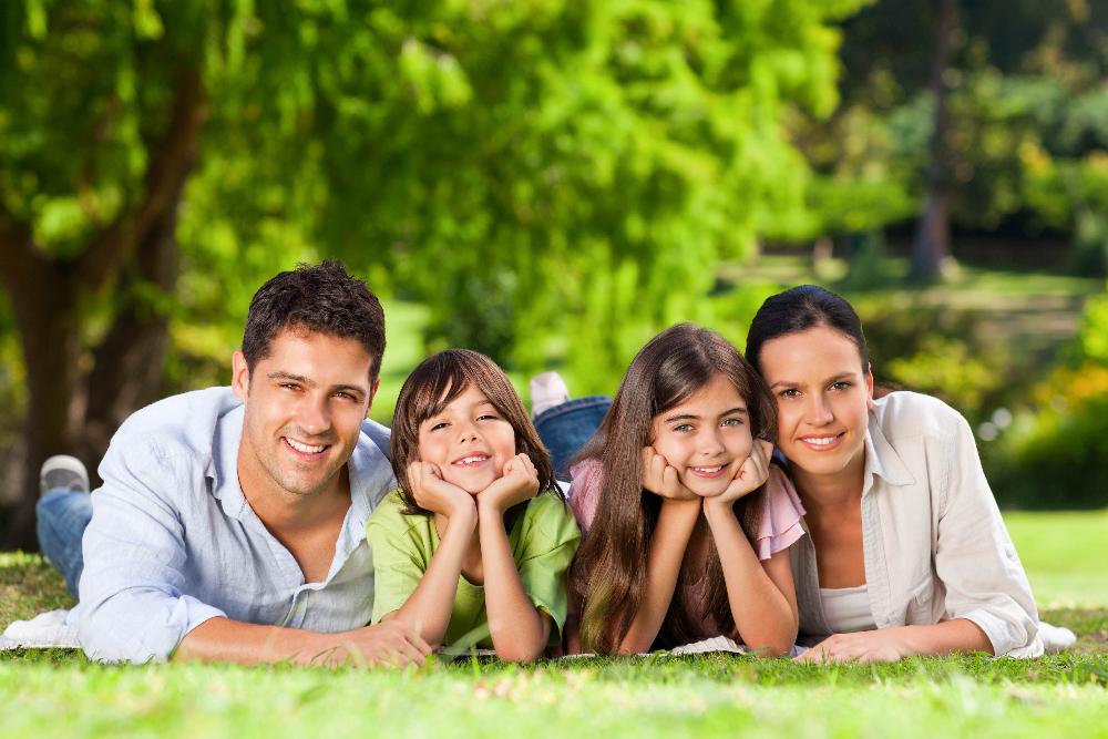 A family of four smiling after a dental visit in Knoxville, TN